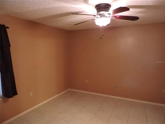 a bathroom with a light fixture and a fan