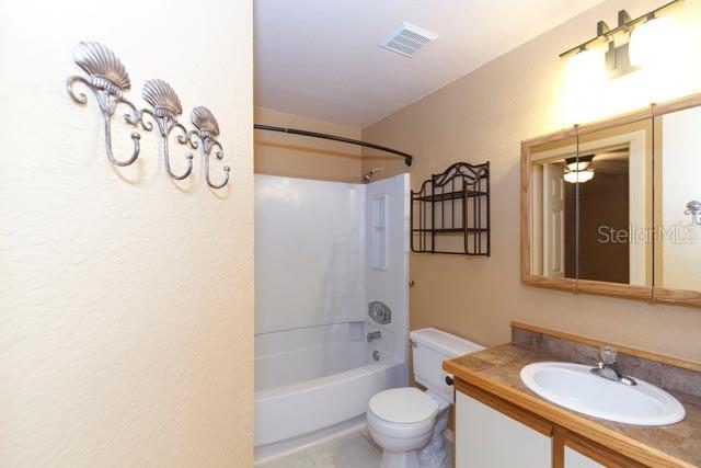 621 Dory Lane, Unit 103 Altamonte Springs, FL 32714 - Photo 10 of 13 a bathroom with a sink a toilet and shower