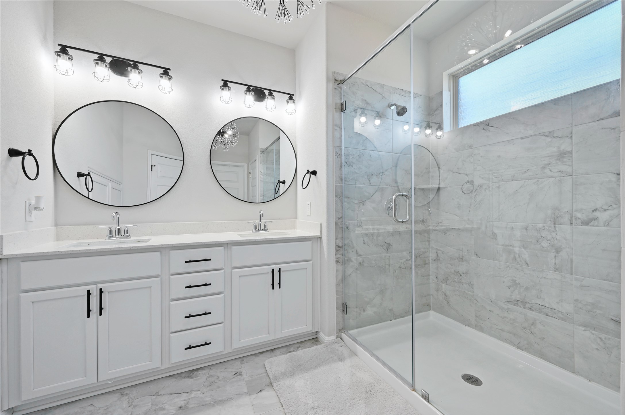 207 Dogvane Circle Kyle, TX 78640 - Photo 17 of 32 Full bathroom featuring double vanity, a marble finish shower, and light marble finish flooring