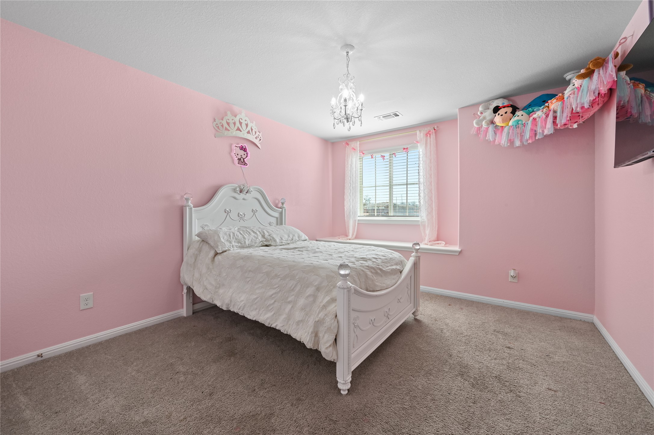 207 Dogvane Circle Kyle, TX 78640 - Photo 24 of 32 Bedroom featuring carpet floors and a chandelier