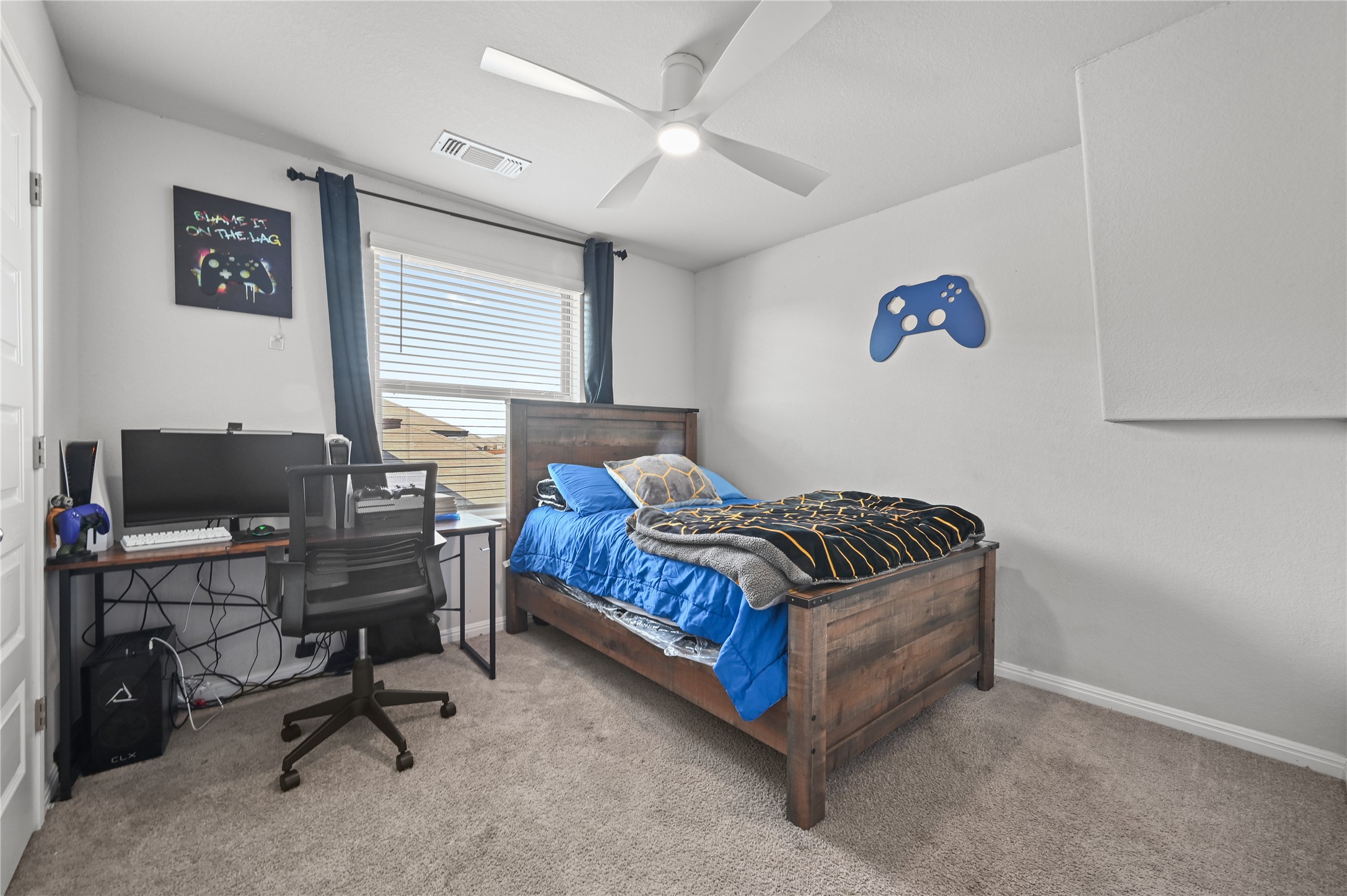 207 Dogvane Circle Kyle, TX 78640 - Photo 26 of 32 Bedroom featuring a desk, carpet floors, and ceiling fan