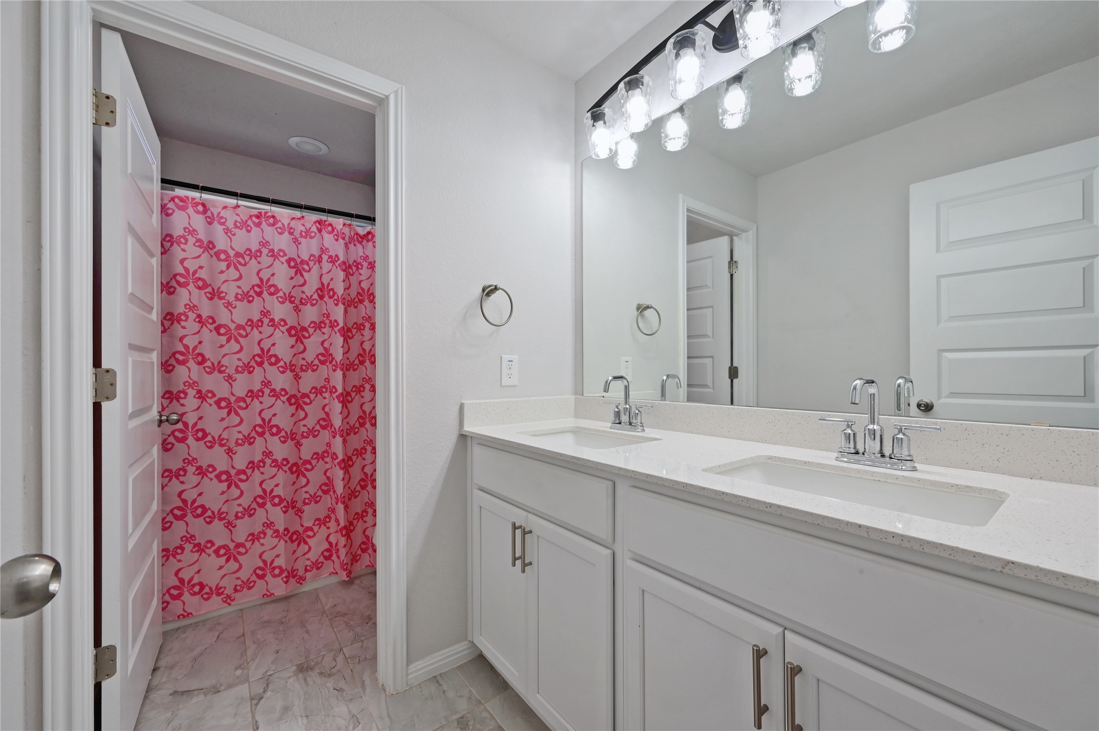207 Dogvane Circle Kyle, TX 78640 - Photo 27 of 32 Full bathroom featuring double vanity and a shower with shower curtain