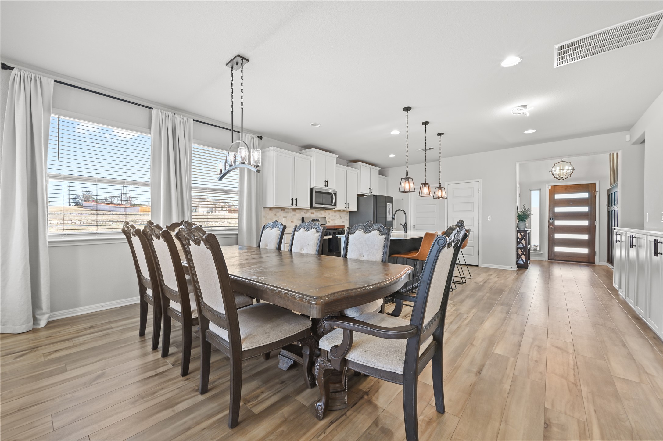 207 Dogvane Circle Kyle, TX 78640 - Photo 10 of 32 Dining space with a chandelier and light wood-type flooring