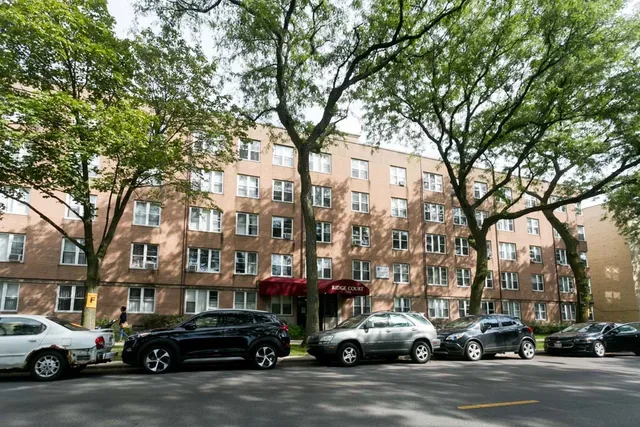a view of a cars parked on the side of a street