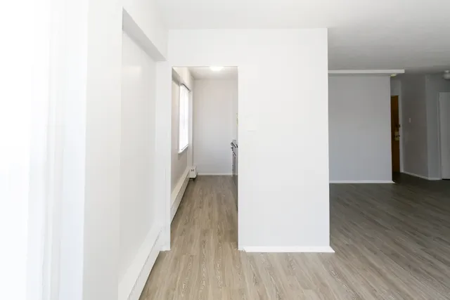 a view of a room with wooden floor