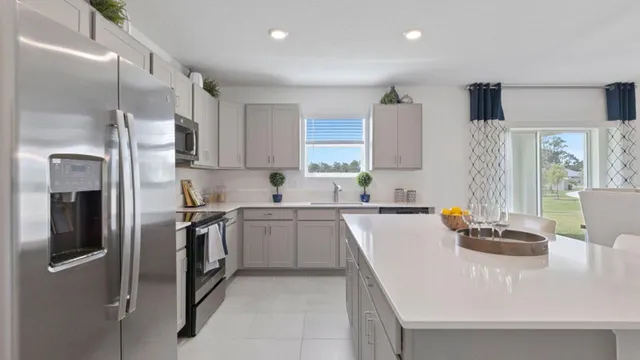 a kitchen with stainless steel appliances granite countertop a sink refrigerator and microwave