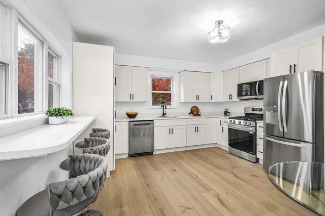 a kitchen with granite countertop stainless steel appliances and wooden cabinets