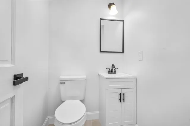 a bathroom with a sink a toilet and mirror
