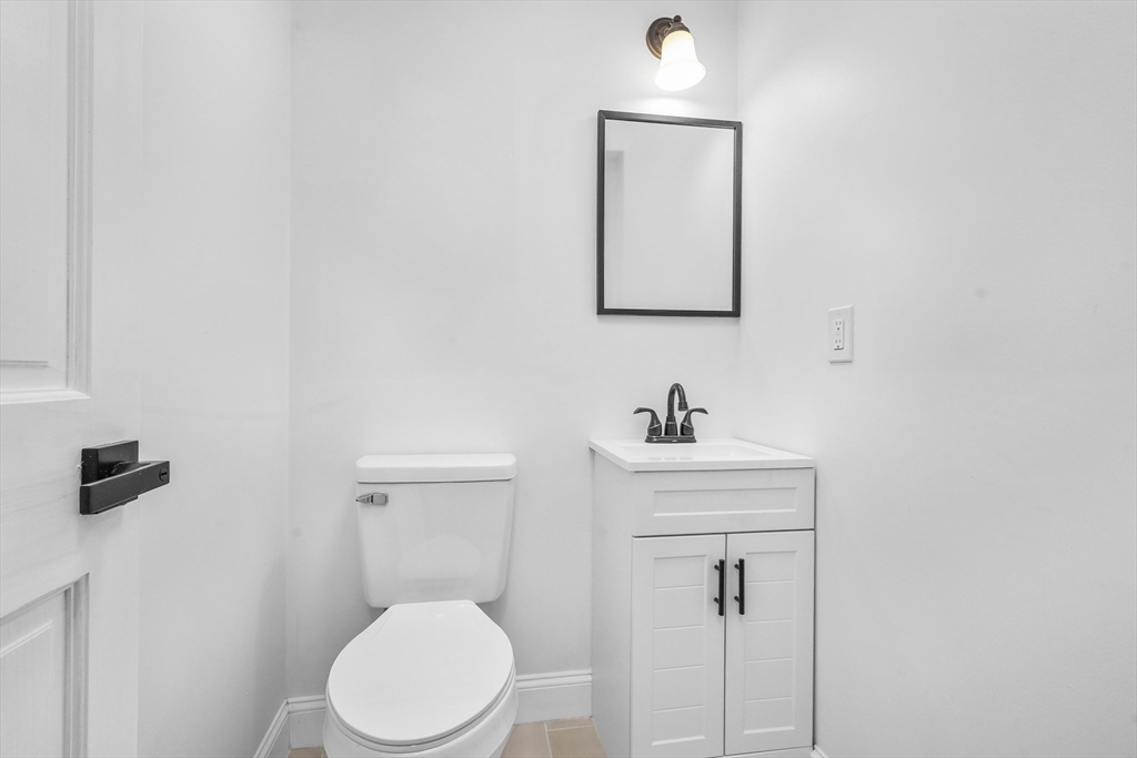 25 Ladd Street, Unit 25 Watertown, MA 02472 - Photo 6 of 16 a bathroom with a sink a toilet and mirror