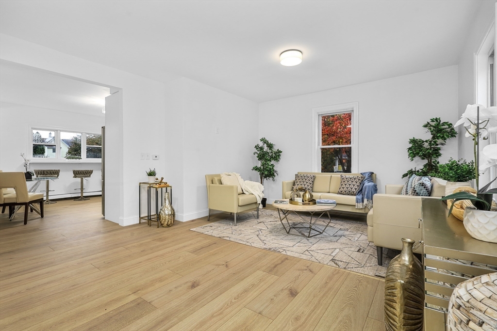 25 Ladd Street, Unit 25 Watertown, MA 02472 - Photo 8 of 16 a living room with furniture and a table