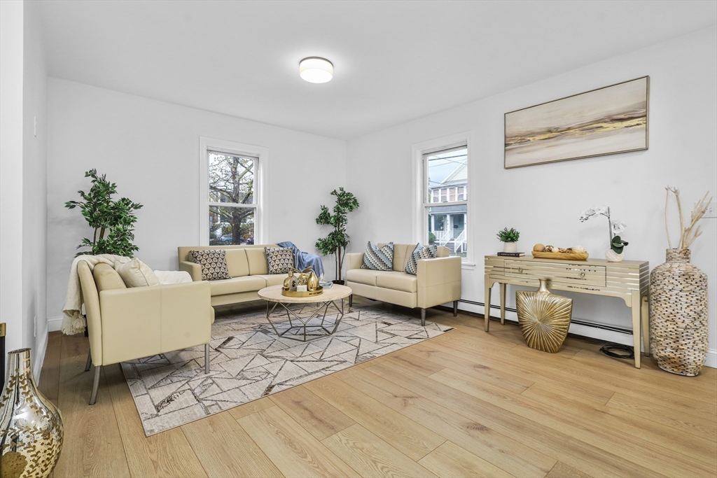 25 Ladd Street, Unit 25 Watertown, MA 02472 - Photo 9 of 16 a living room with furniture and wooden floor