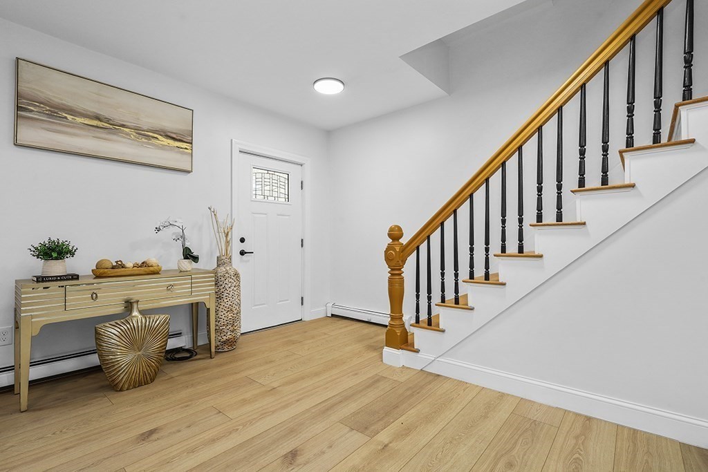 25 Ladd Street, Unit 25 Watertown, MA 02472 - Photo 10 of 16 a view of a livingroom with wooden floor and staircase