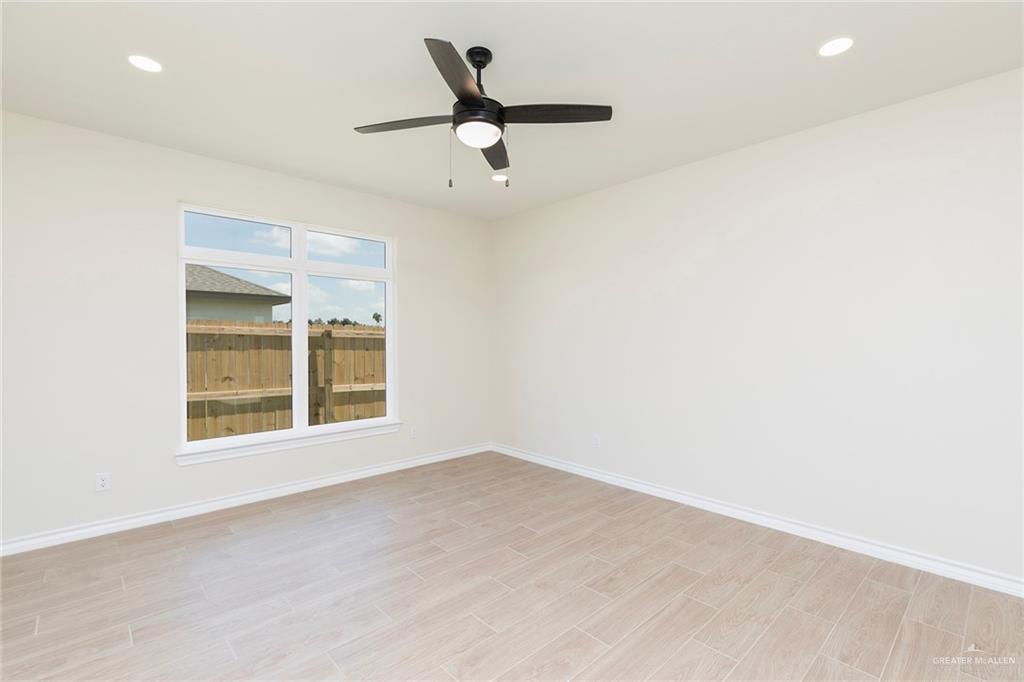 8030 North 50th Street McAllen, TX 78504 - Photo 14 of 23 Empty room with recessed lighting, light wood-style flooring, and a ceiling fan