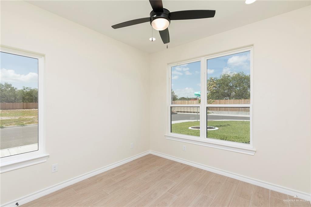 8030 North 50th Street McAllen, TX 78504 - Photo 18 of 23 Empty room with light wood-style floors, a ceiling fan, and recessed lighting