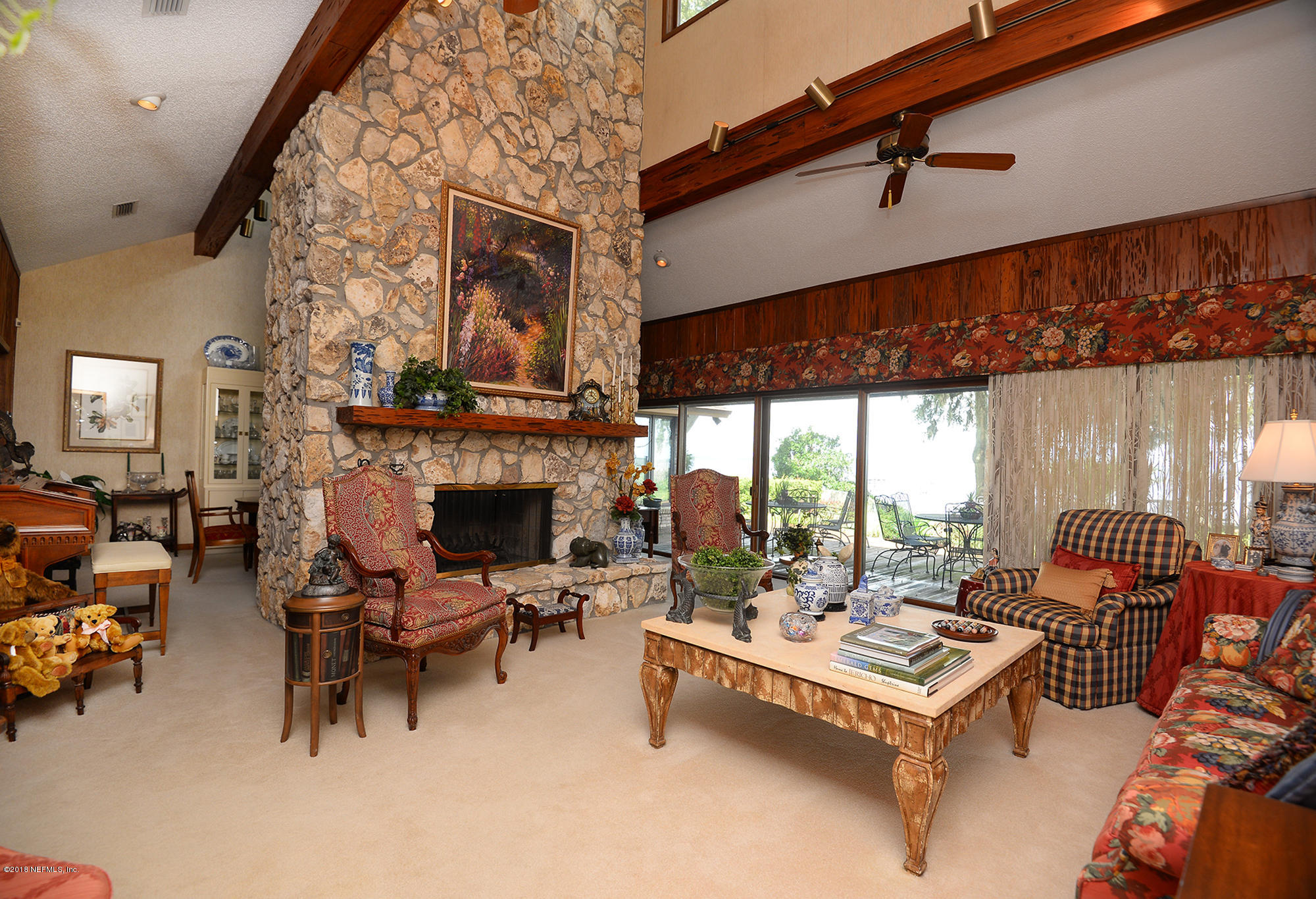 2963 Front Road Jacksonville, FL 32257 - Photo 12 of 63 a living room with furniture a fireplace and a table