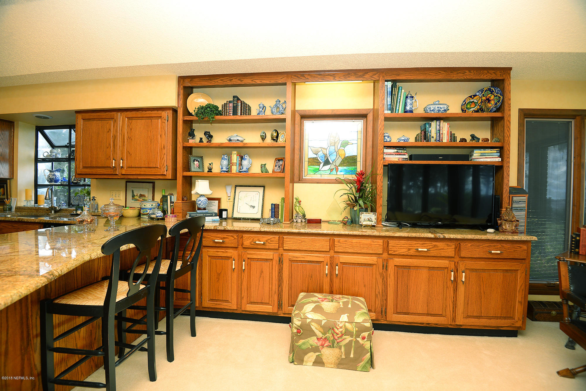 2963 Front Road Jacksonville, FL 32257 - Photo 23 of 63 a kitchen with stainless steel appliances granite countertop a table and chairs in it