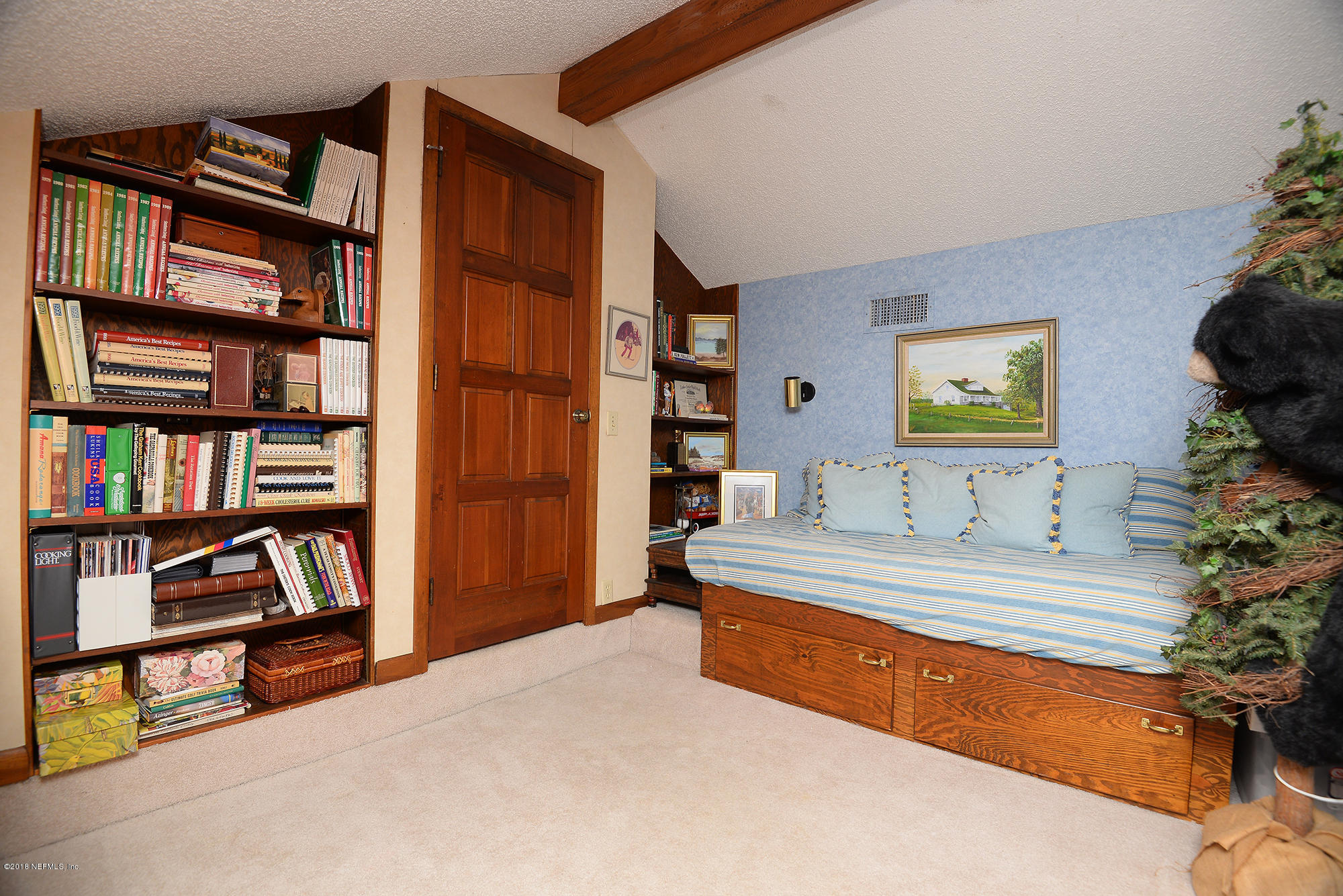 2963 Front Road Jacksonville, FL 32257 - Photo 34 of 63 a spacious bedroom with a bed and a book shelf