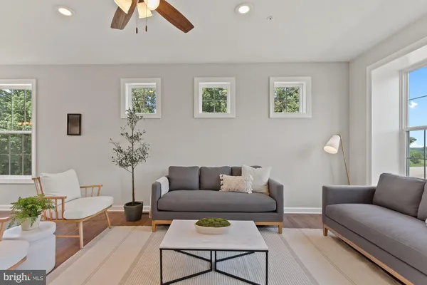 a living room with furniture and wooden floor