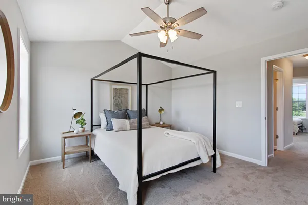 a bedroom with a bed a chandelier and a chandelier