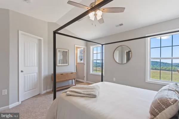 a bedroom with a large bed and a window