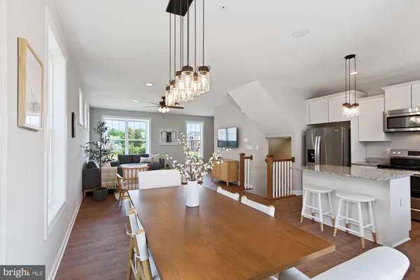 a living room with furniture a chandelier and a dining table