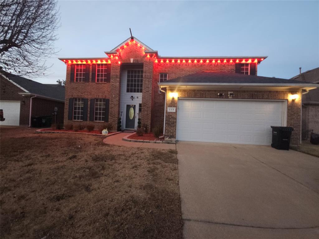 233 Keswick Lane Mesquite, TX 75150 - Photo 2 of 2 View of front of house with brick siding, concrete driveway, an attached garage, and a front lawn