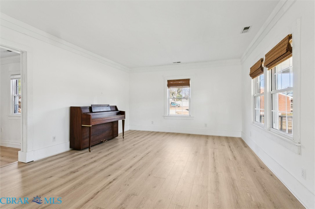 2290 Hayes Road Hayes, VA 23072 - Photo 6 of 32 Unfurnished room featuring light wood finished floors and crown molding