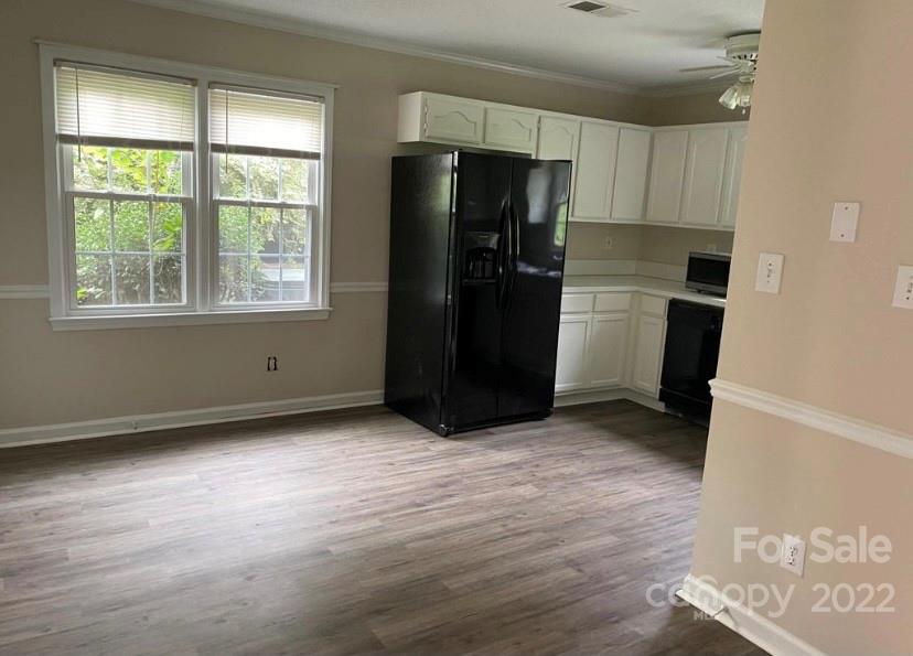12737 Levins Hall Road Huntersville, NC 28078 - Photo 3 of 3 an empty room with a window and a refrigerator