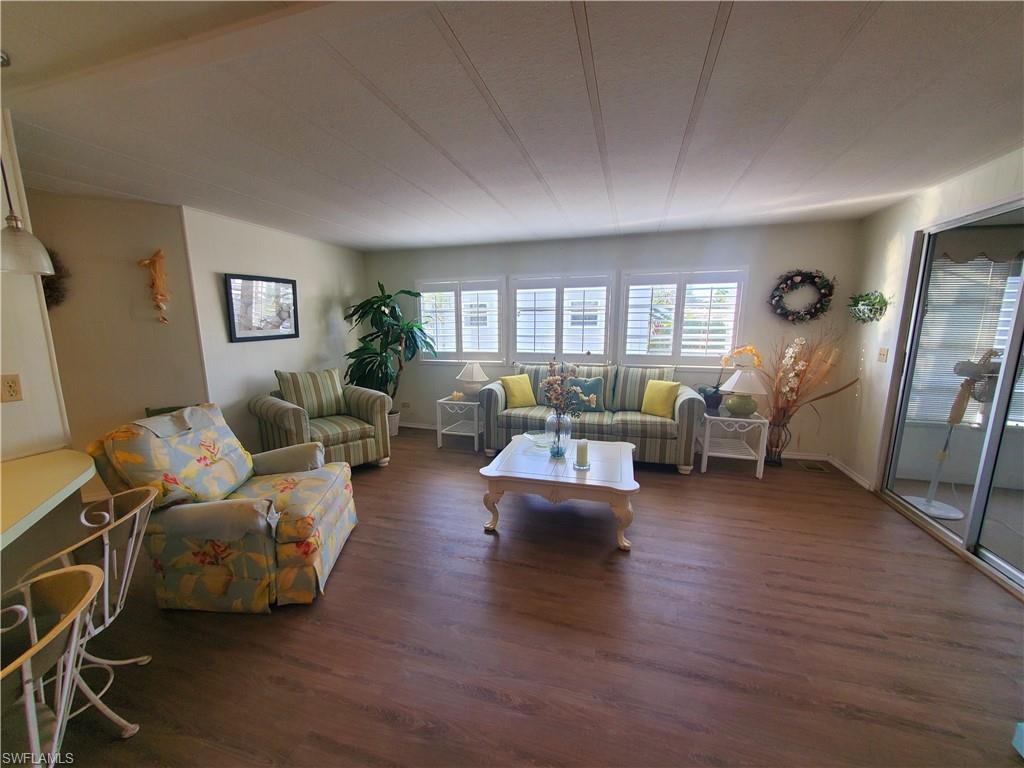 4 Topaz Lane, Unit T4 Naples, FL 34112 - Photo 1 of 17 a living room with furniture and wooden floor