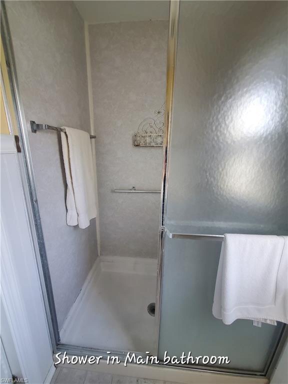 4 Topaz Lane, Unit T4 Naples, FL 34112 - Photo 12 of 17 a bathroom with a glass shower door