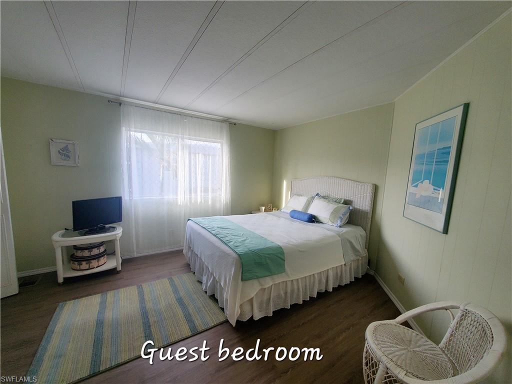 4 Topaz Lane, Unit T4 Naples, FL 34112 - Photo 14 of 17 a bedroom with a bed and a couch