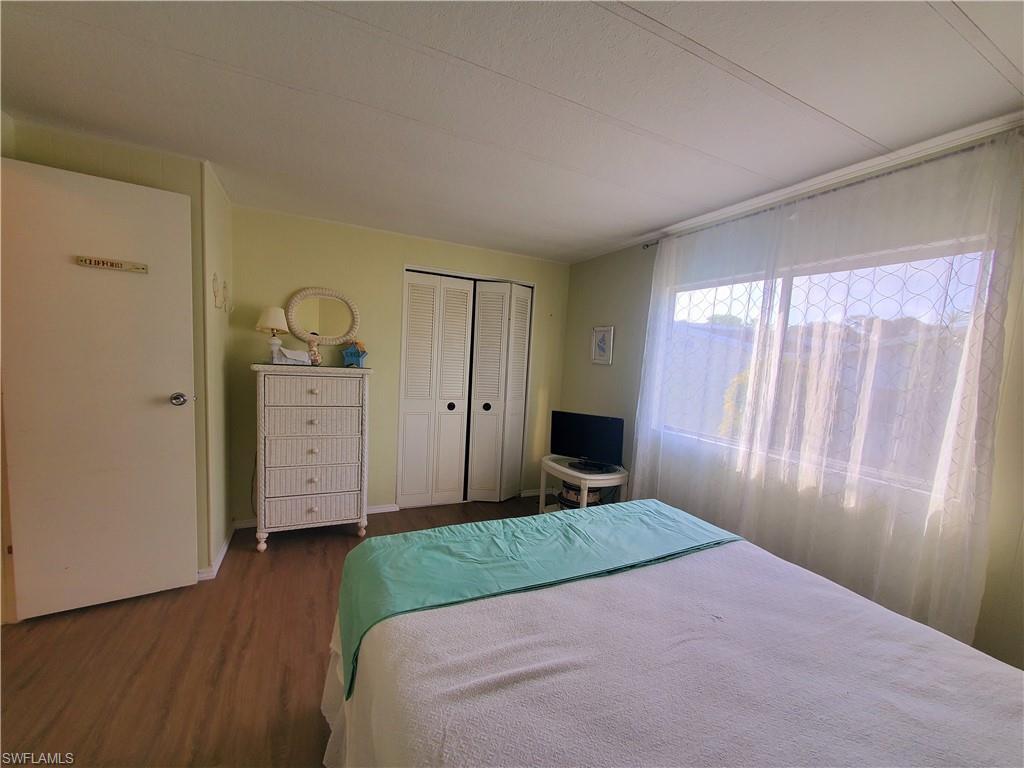 4 Topaz Lane, Unit T4 Naples, FL 34112 - Photo 15 of 17 a bedroom with a bed and a closet