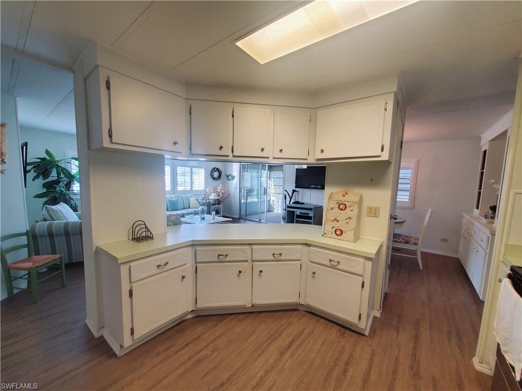 4 Topaz Lane, Unit T4 Naples, FL 34112 - Photo 4 of 17 a kitchen with white cabinets and sink
