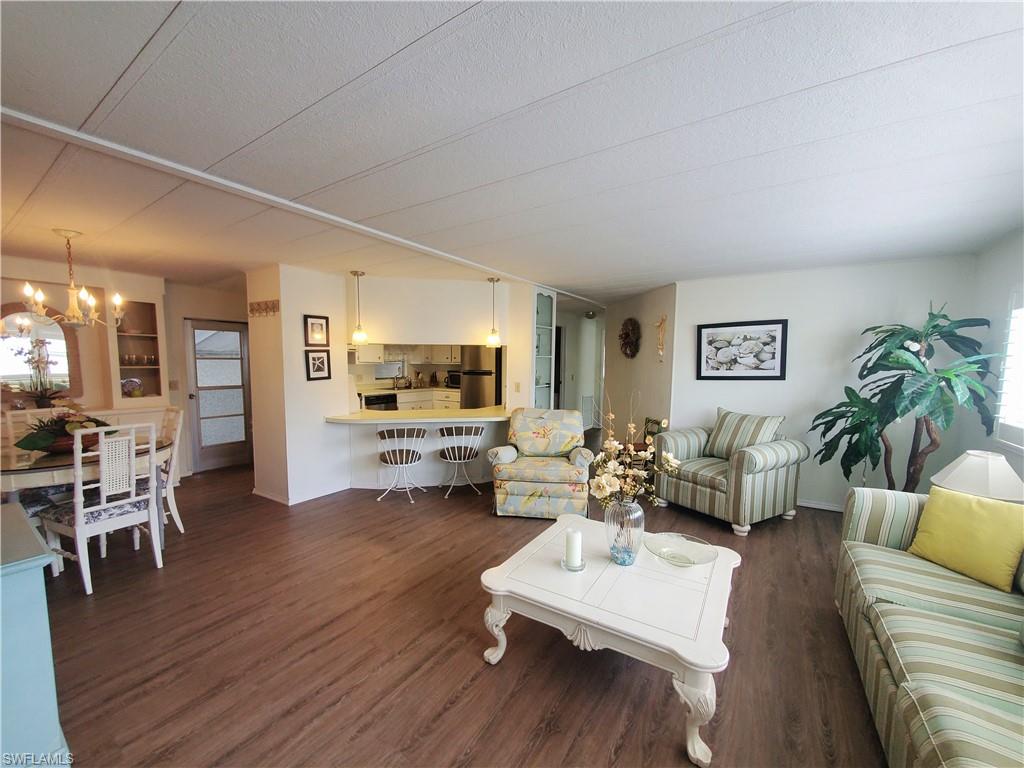 4 Topaz Lane, Unit T4 Naples, FL 34112 - Photo 6 of 17 a living room with furniture and a wooden floor