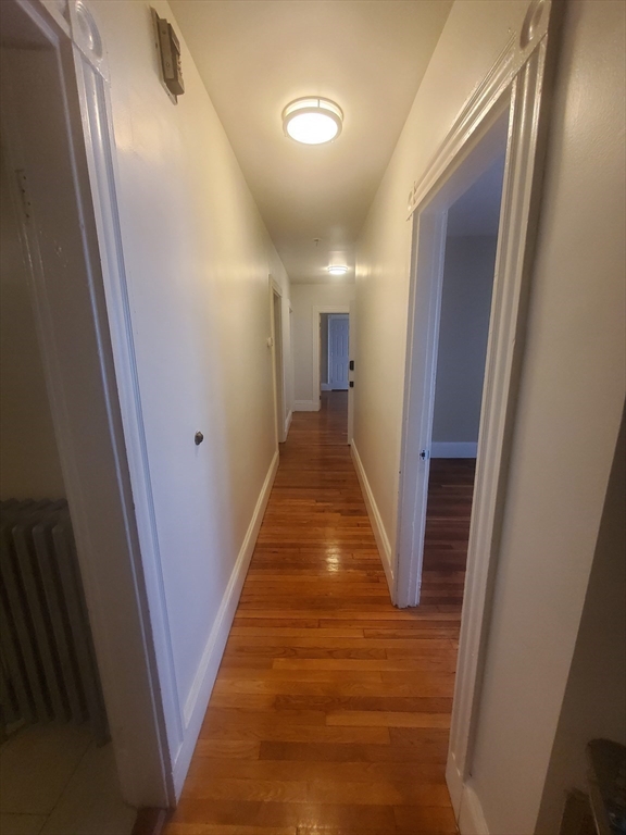 45 Intervale Street, Unit 2 Boston, MA 02121 - Photo 6 of 17 a view of a hallway with wooden floor and staircase