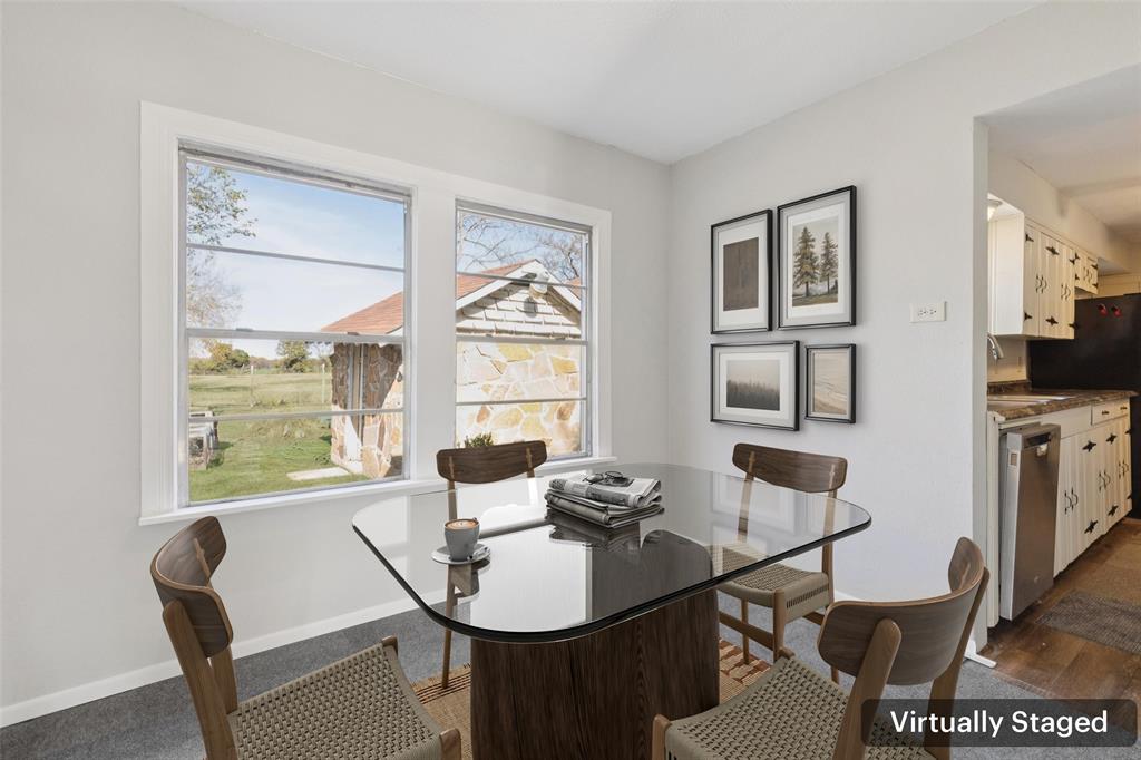 10609 Seagoville Road Dallas, TX 75217 - Photo 11 of 33 a view of a dining room with furniture a rug and wooden floor