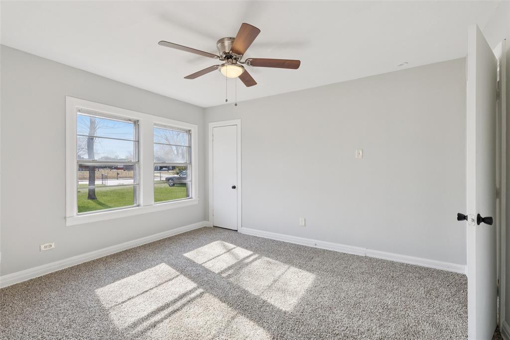 10609 Seagoville Road Dallas, TX 75217 - Photo 14 of 33 a view of a big room with windows and chandelier fan