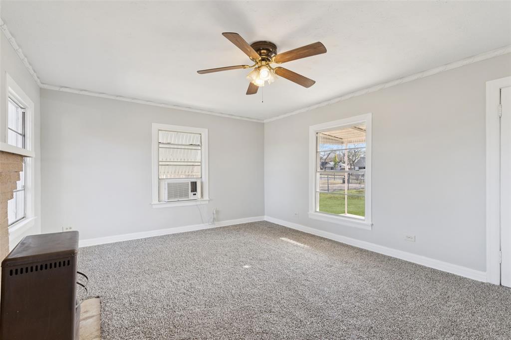 10609 Seagoville Road Dallas, TX 75217 - Photo 15 of 33 a view of a livingroom with a ceiling fan and window