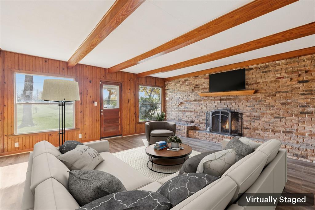 10609 Seagoville Road Dallas, TX 75217 - Photo 2 of 33 a living room with fireplace furniture and a flat screen tv