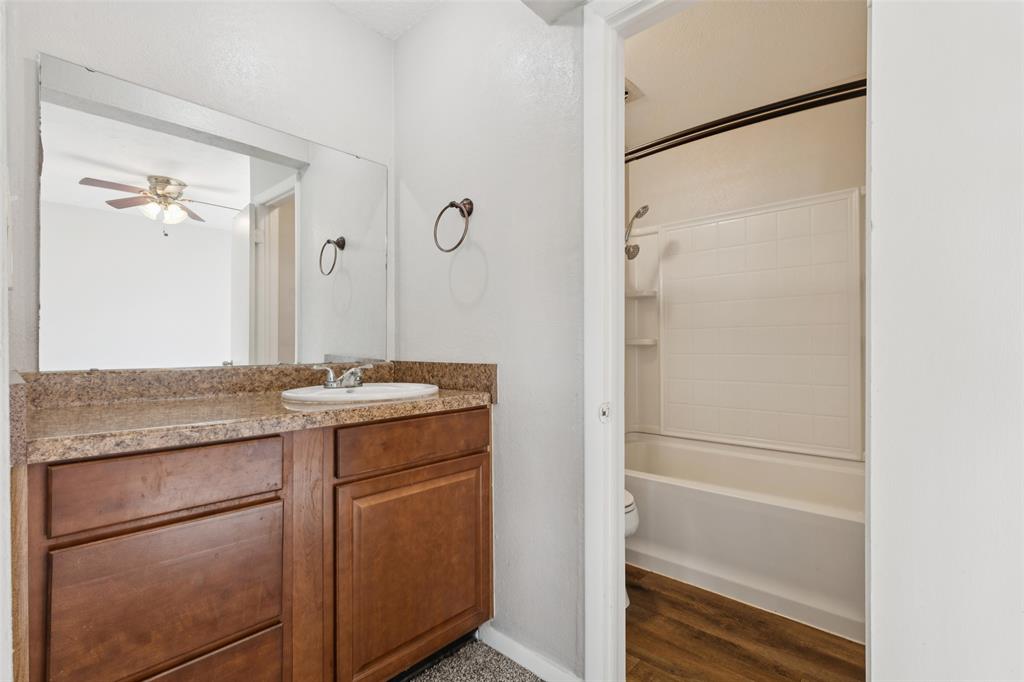 10609 Seagoville Road Dallas, TX 75217 - Photo 24 of 33 a bathroom with a granite countertop sink and a mirror