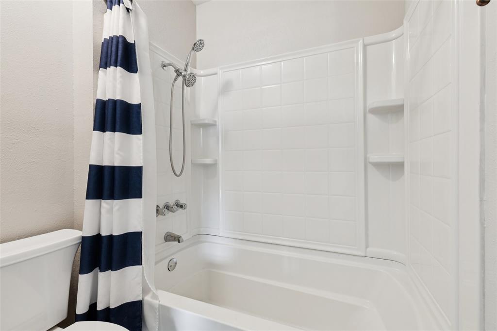 10609 Seagoville Road Dallas, TX 75217 - Photo 25 of 33 a bathroom with a bathtub and a shower