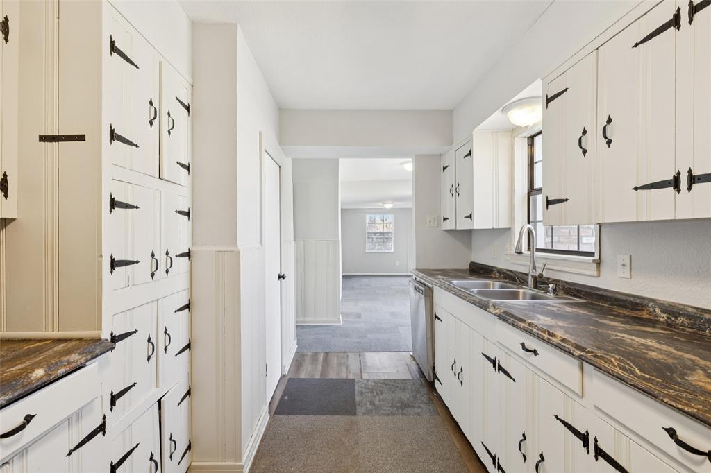 10609 Seagoville Road Dallas, TX 75217 - Photo 10 of 33 a large white kitchen with granite countertop a sink