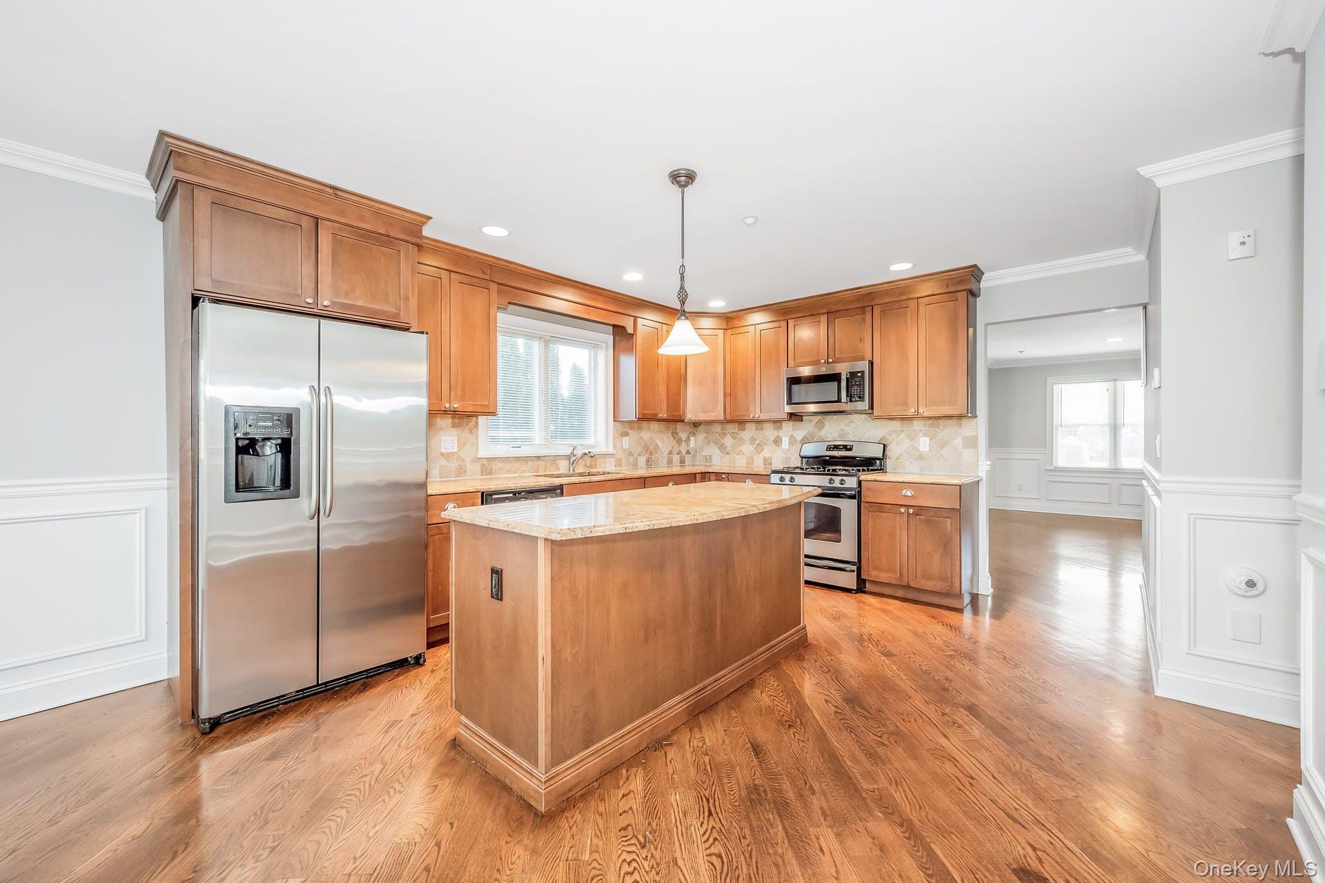 85 Park Avenue, Unit RIGHT SIDE West Harrison, NY 10604 - Photo 11 of 46 a kitchen with stainless steel appliances granite countertop a refrigerator a sink dishwasher a oven with white cabinets and wooden floor