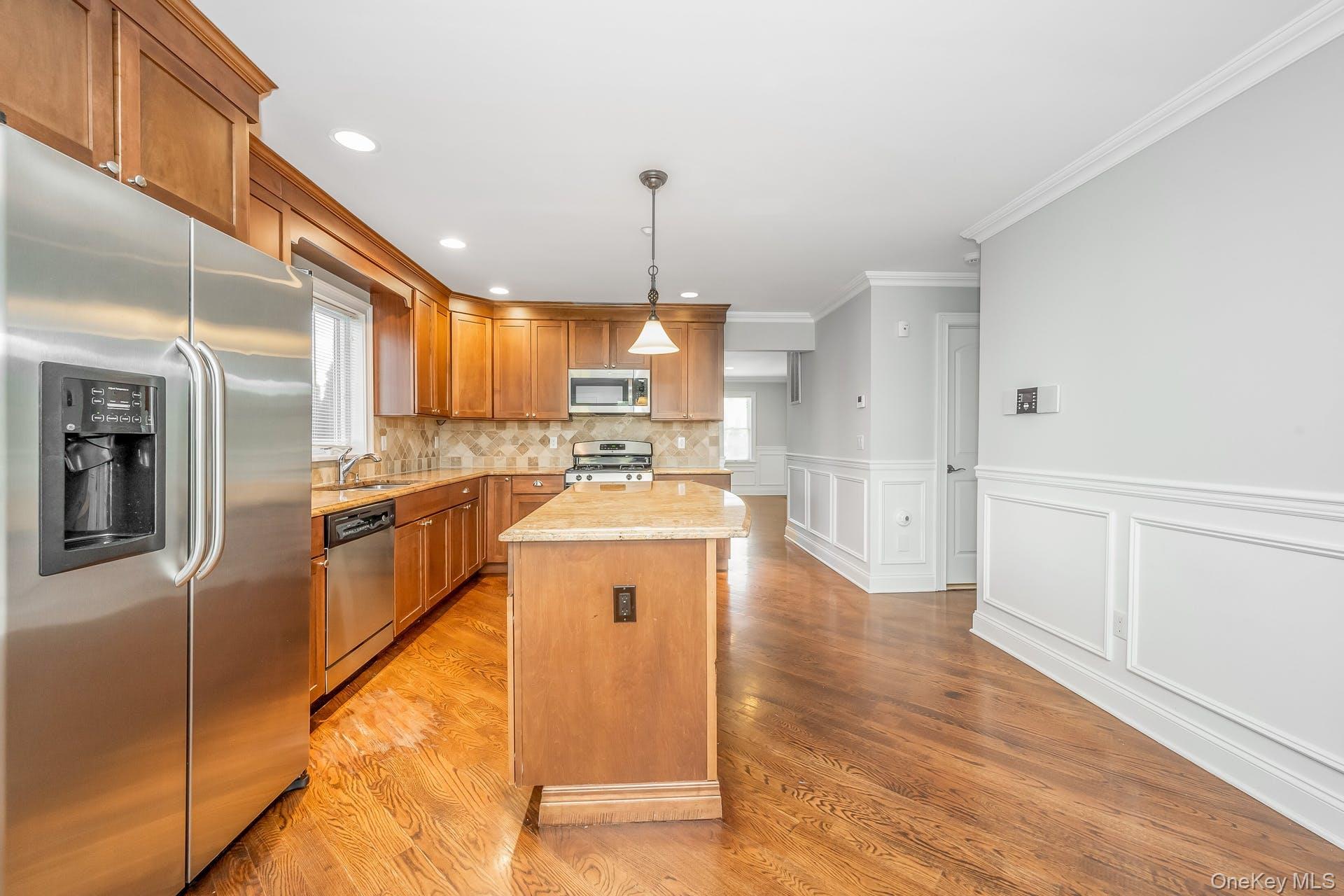 85 Park Avenue, Unit RIGHT SIDE West Harrison, NY 10604 - Photo 12 of 46 a kitchen with stainless steel appliances granite countertop a refrigerator a sink dishwasher a stove and white cabinets with wooden floor