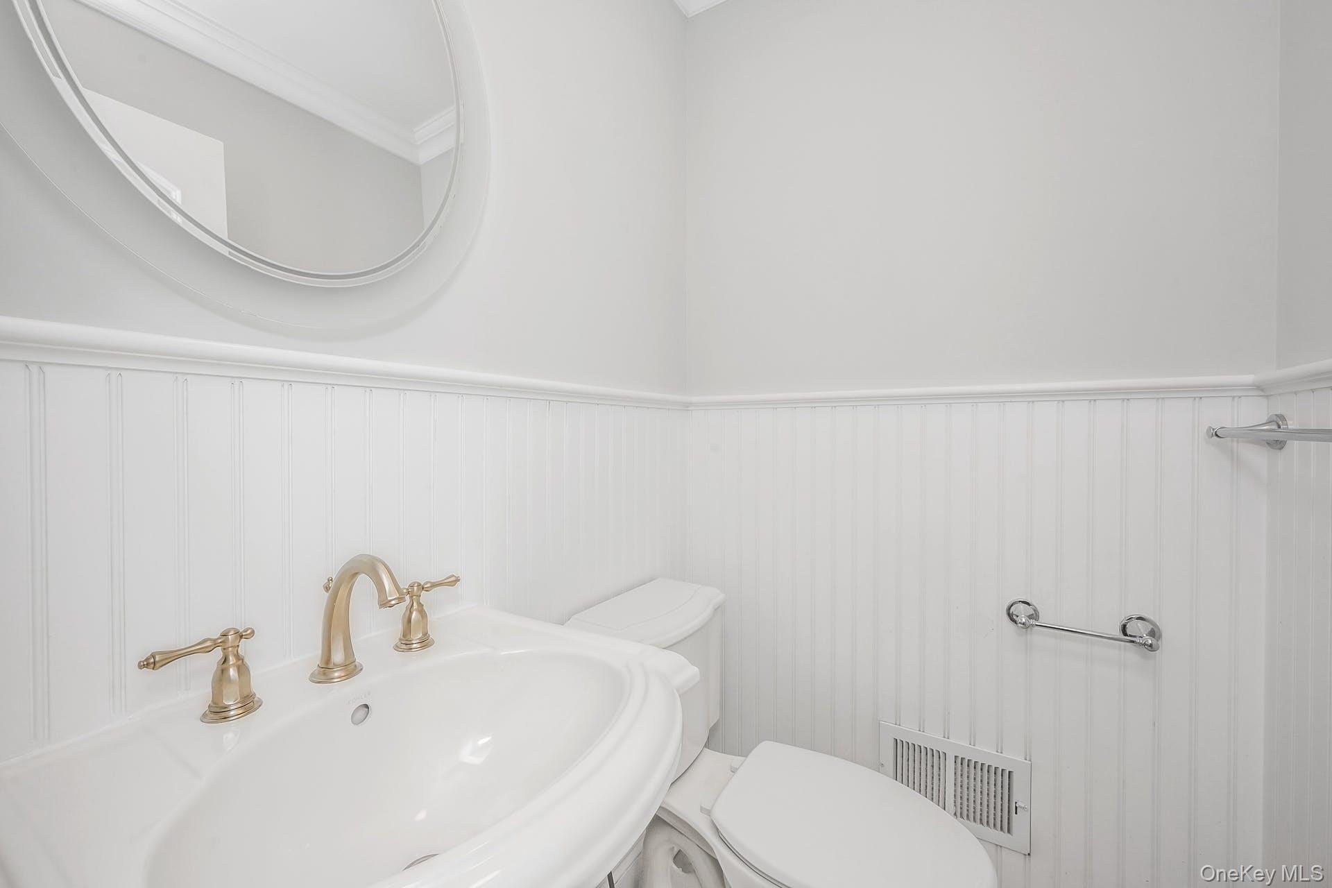 85 Park Avenue, Unit RIGHT SIDE West Harrison, NY 10604 - Photo 16 of 46 a bathroom with a toilet a sink and mirror