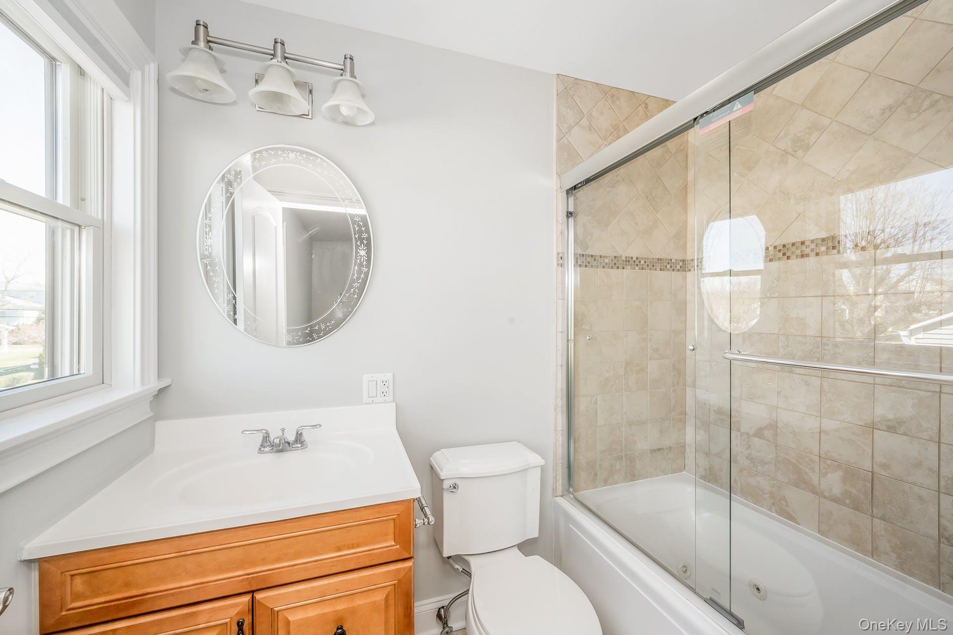 85 Park Avenue, Unit RIGHT SIDE West Harrison, NY 10604 - Photo 22 of 46 a bathroom with a granite countertop sink mirror vanity and toilet