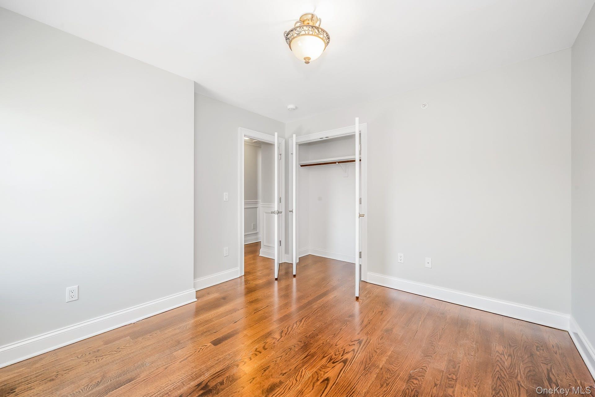 85 Park Avenue, Unit RIGHT SIDE West Harrison, NY 10604 - Photo 28 of 46 a view of empty room with wooden floor and fan