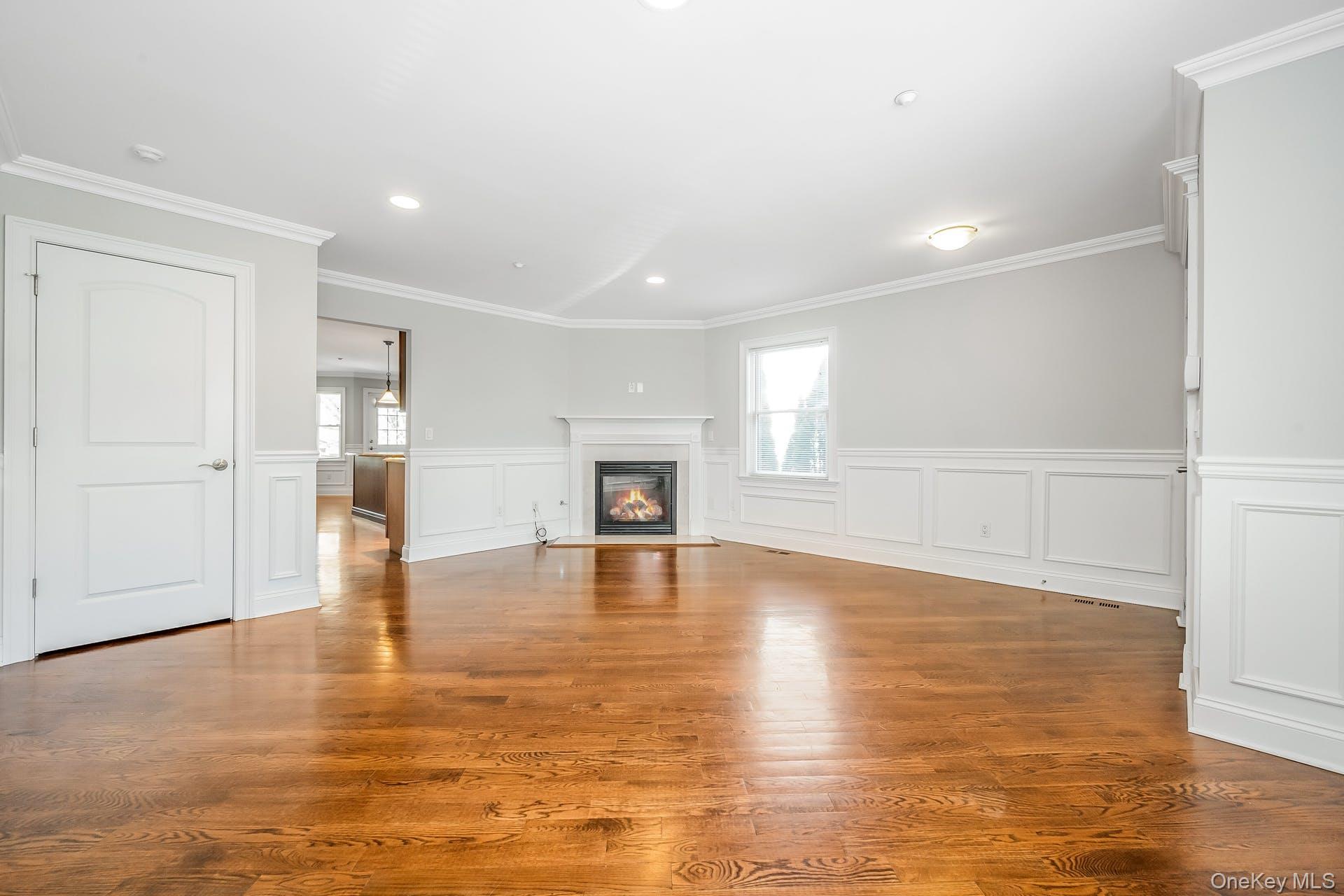 85 Park Avenue, Unit RIGHT SIDE West Harrison, NY 10604 - Photo 6 of 46 a view of empty room with wooden floor and kitchen