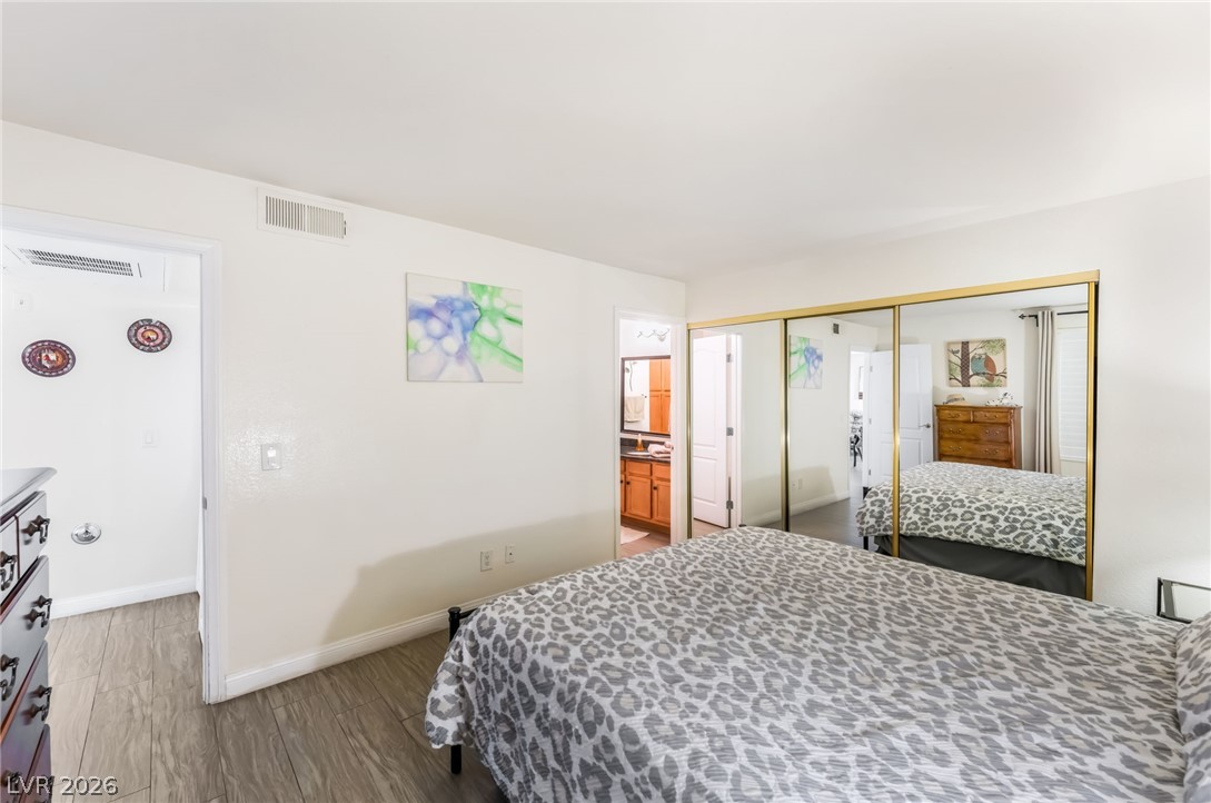 3145 East Flamingo Road, Unit 1092 Las Vegas, NV 89121 - Photo 15 of 33 Well-lit sleeping quarters with elegant mirrored closet doors.