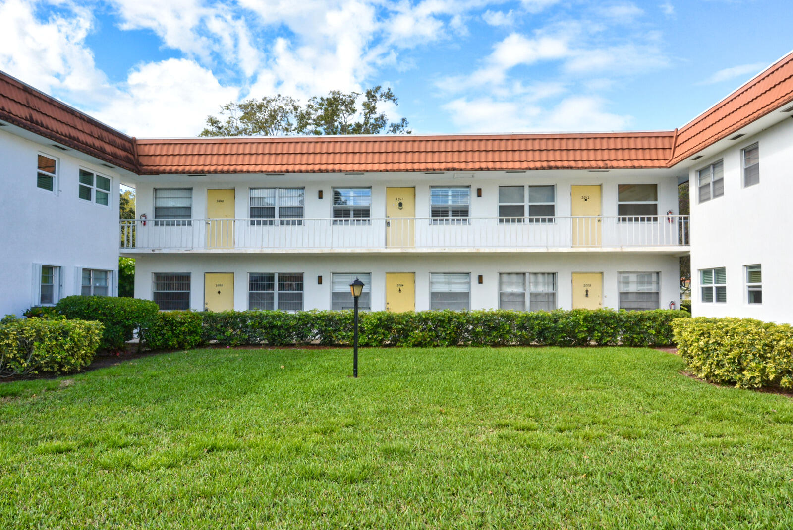 1225 Northwest 21st Street, Unit 2003 Stuart, FL 34994 - Photo 1 of 30 a front view of a house with a yard